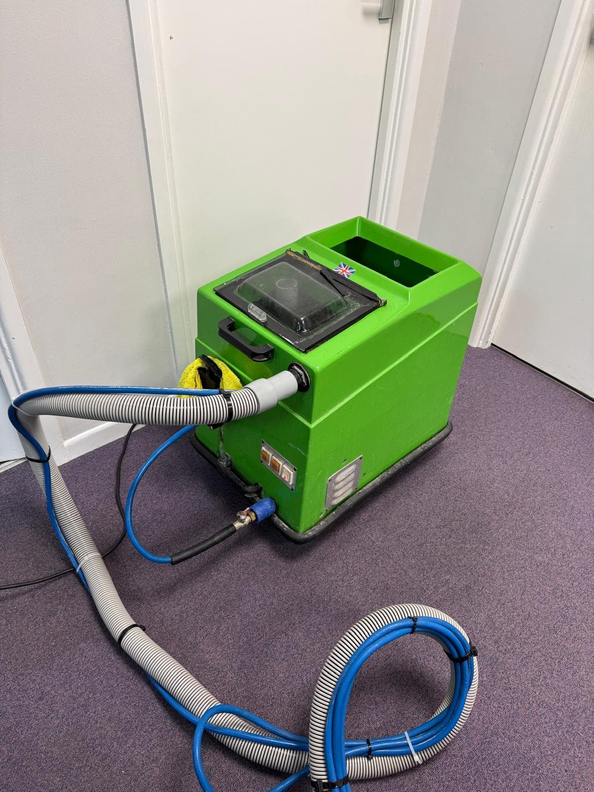 Professional carpet cleaning machine in use on commercial property carpet in London